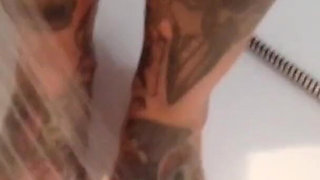 Tattooed blonde MILF washes her feet