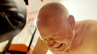 Hot waxing the bald head of the prisoner