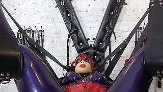 Sissy is bound in latex bondage and punished by dominatrix