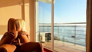 Slender blonde beauty has sex with her lover by the window