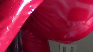 MILF in Red Latex Suit and Patent Leather High Heels Gives a Blowjob with Swallow