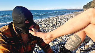 It's wonderful to listen to the sound of the sea while a slave sucks my toes. Dominatrix Nika and her foot slave.