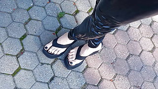 high platform flip flops and latex leggings in public