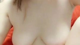A young woman with beautiful breasts shows her face and earns extra money by making money while taking a bath in the bathroom is seductive and charming