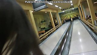 Super-flexible chick blowing, while guys play bowling