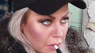 Blonde lady smokes an electronic cigarette