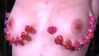 Milf gets strawberry round her tits while gagged and on bondage