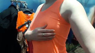 Brunette teen masturbates in a public fitting room.