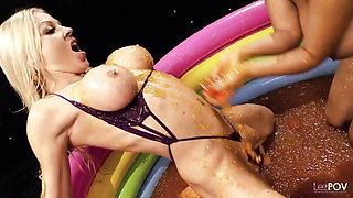 Very sloppy yet enticing lesbians sex in a pool filled with jelly between two stimulating Brit bitches