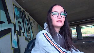 Glasses girl strokes that dick and takes it under the bridge