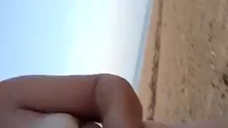 Hot couple on the Nudian beach enjoying handjob in the sea air