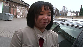 German slut with Asian origins stuffs her cunt with dildo