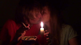 Couple smoke next to candle