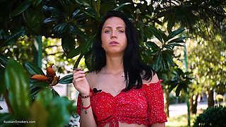 Sultry Brunette in Red Dress Smoking Rolled Cigarette
