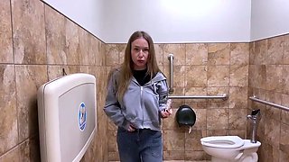 Wild teen gets herself off with a sex toy in a public toilet