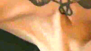 Tattooed teen is dancing in the dark room