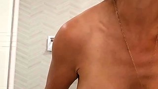 Busty babe playing with her big boobs
