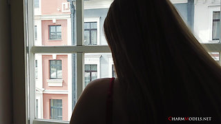 Elegant Glamour Babe Evelina in Red Lingerie at Window