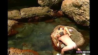 Amateur Brunette in Orange Cap Solo Striptease on Rocks by Natural Pool